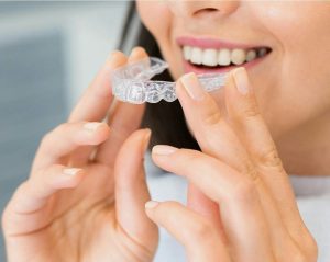 Smiling Invisalign patient for clear aligners in Round Rock TX at Red Bud Dental